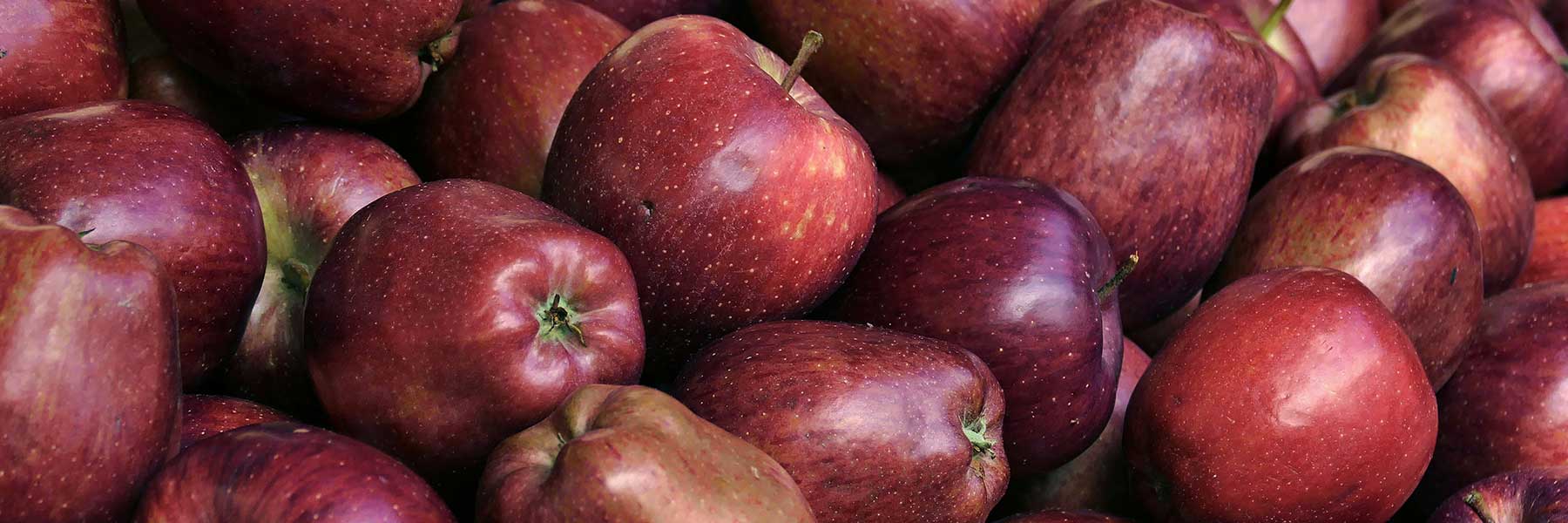 A pile of red apples closely stacked together.