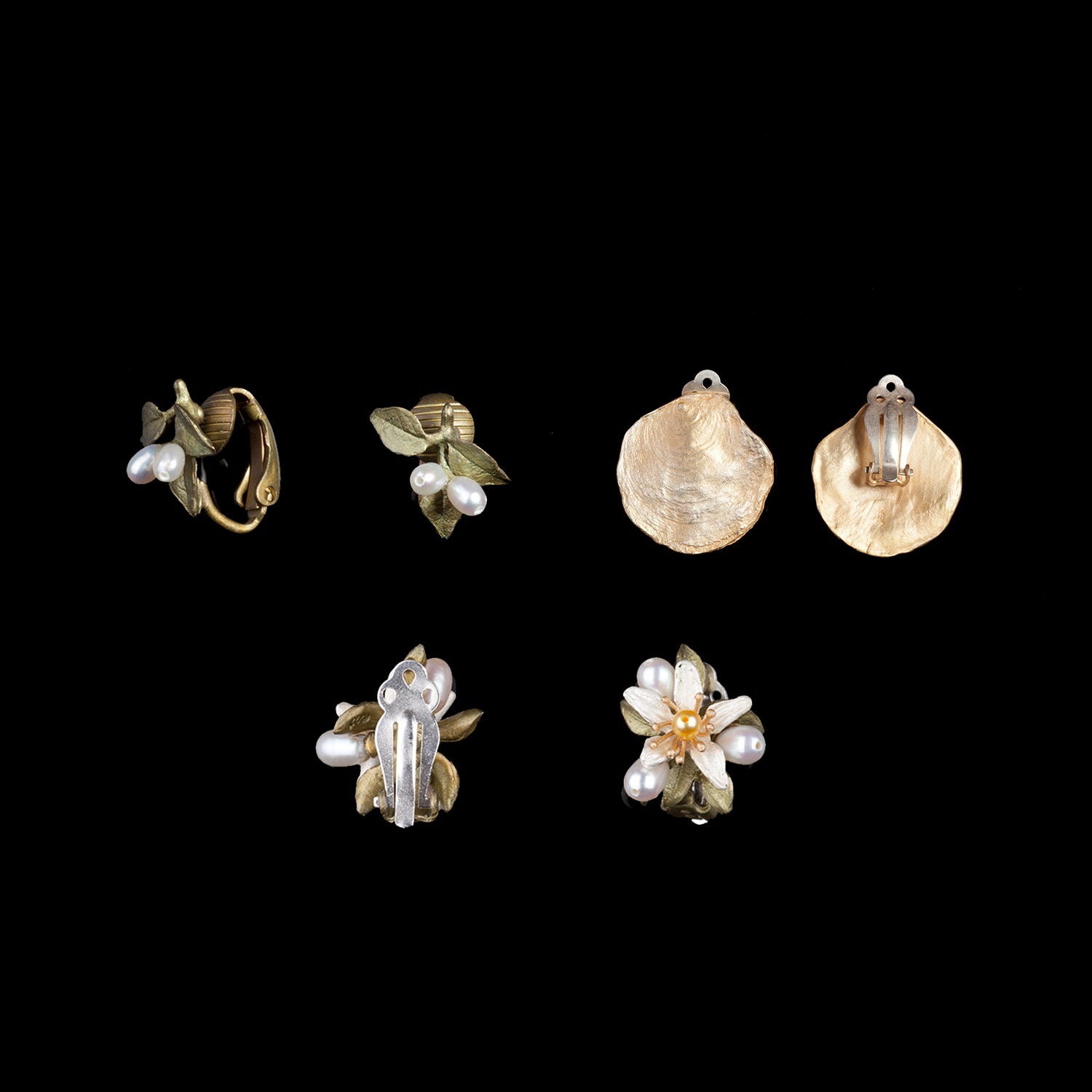 Six pairs of vintage-style earrings featuring floral and leaf designs, pearls, and gold-toned metal, displayed on a black background.