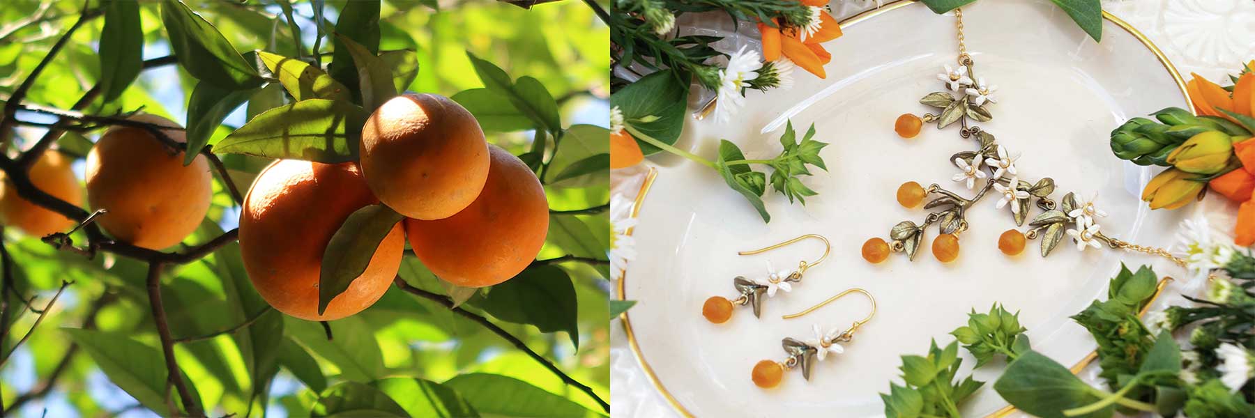 Cluster of ripe oranges hanging on a tree next to a display of jewelry inspired by oranges, including earrings and a necklace, on a white plate with flowers.