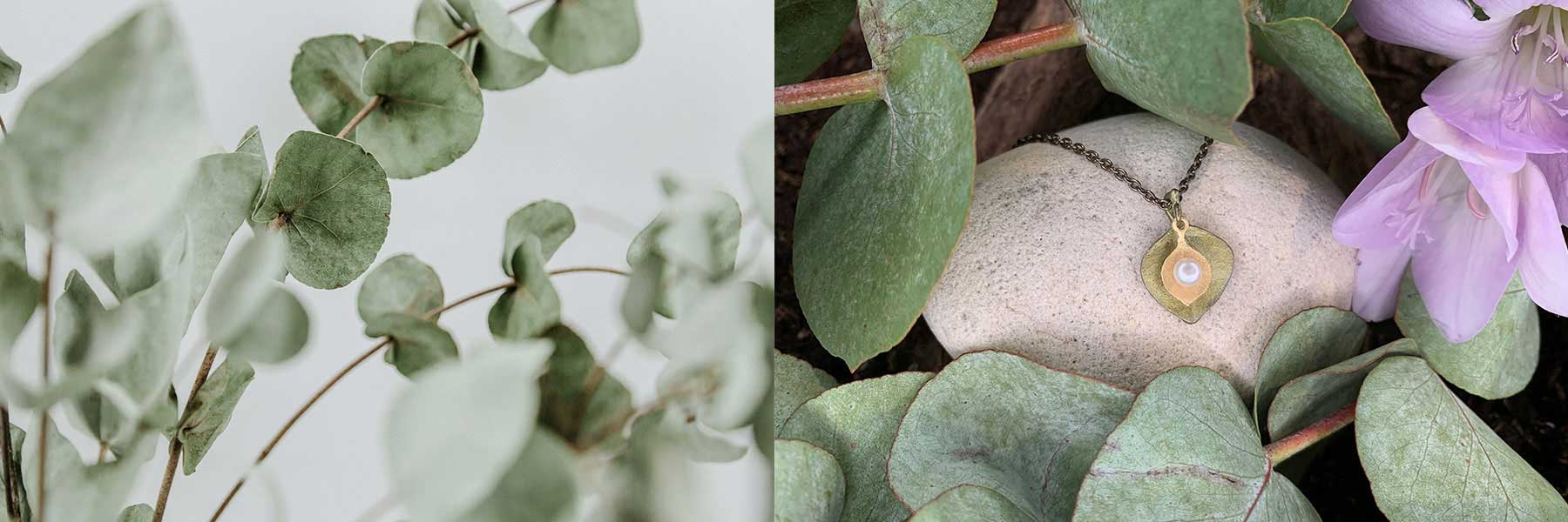 Close-up of eucalyptus leaves on the left; on the right, a gold pendant necklace with a white center rests on a stone surrounded by green leaves and a pink flower.