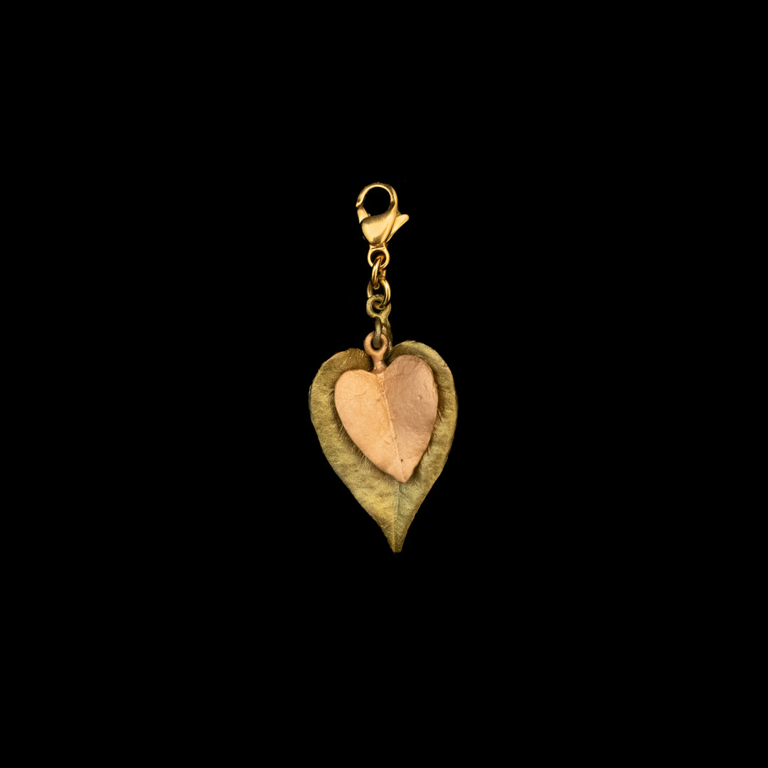 Image of the Michael Michaud Sweet Potato Charm on a black background