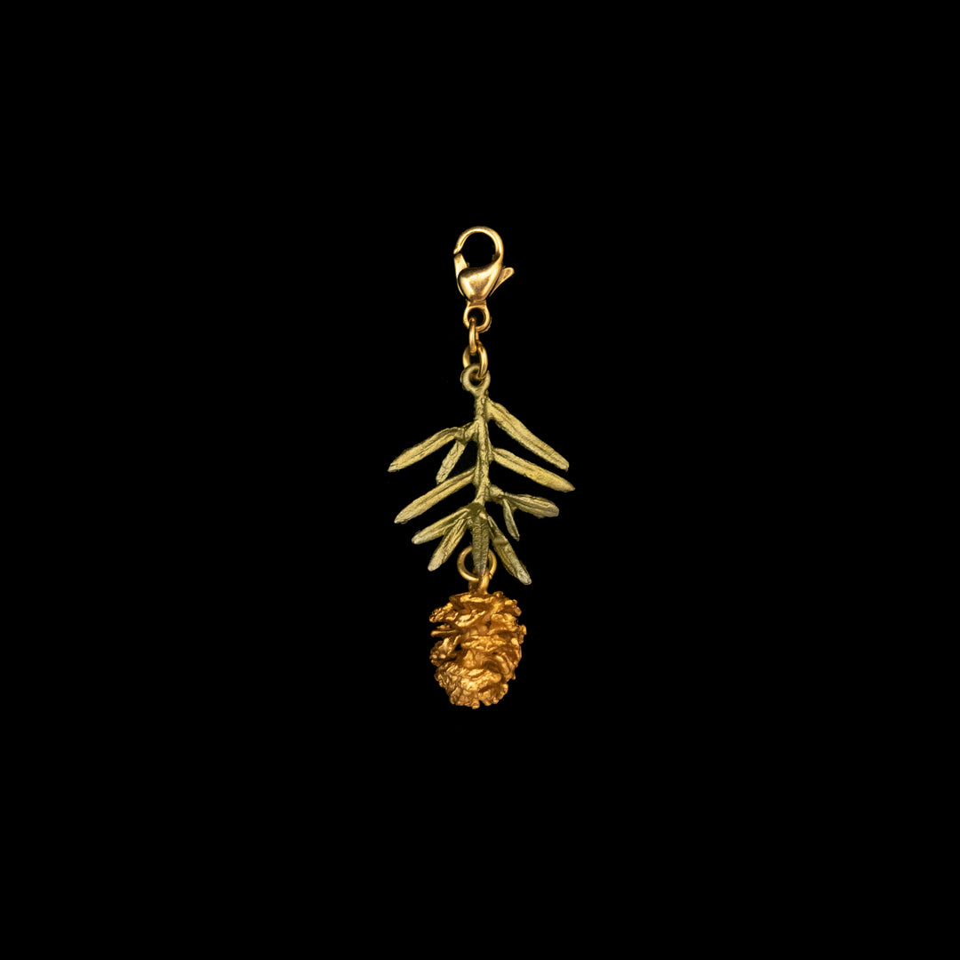 Image of the Michael Michaud Pine Needle Charm on a black background