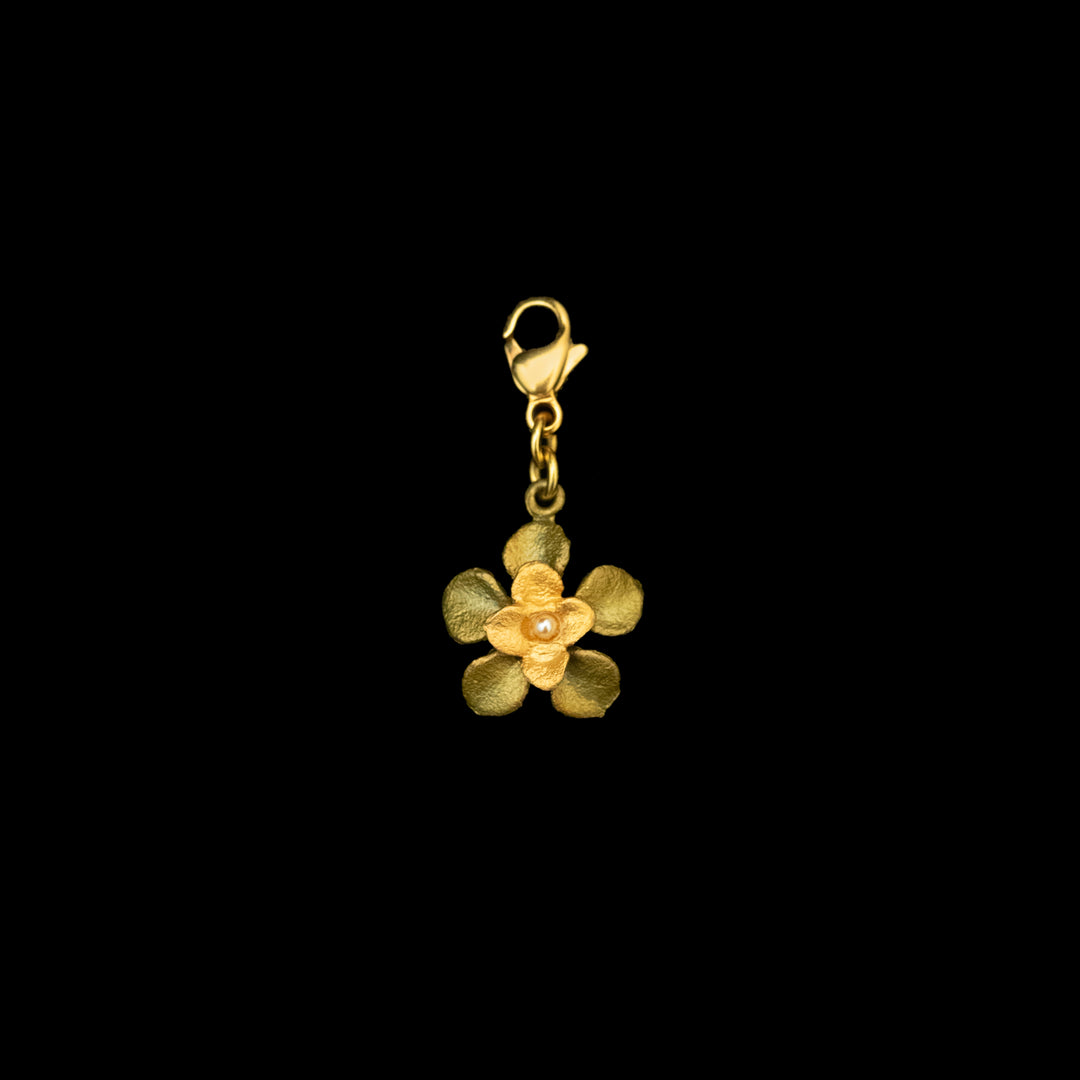 Image of the Michael Michaud Desert Flower Charm on a black background