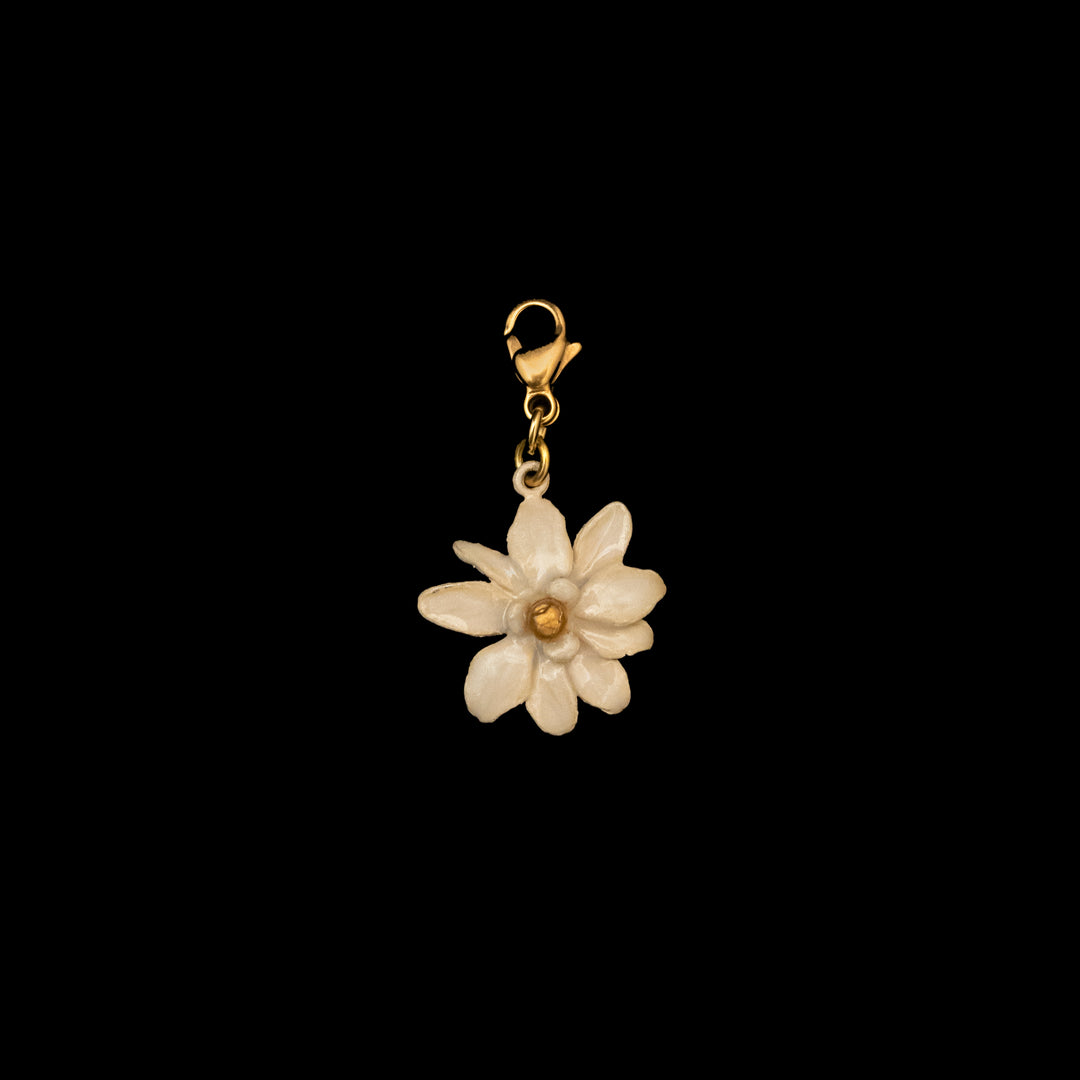 Image of the Michael Michaud Magnolia Charm on a black background