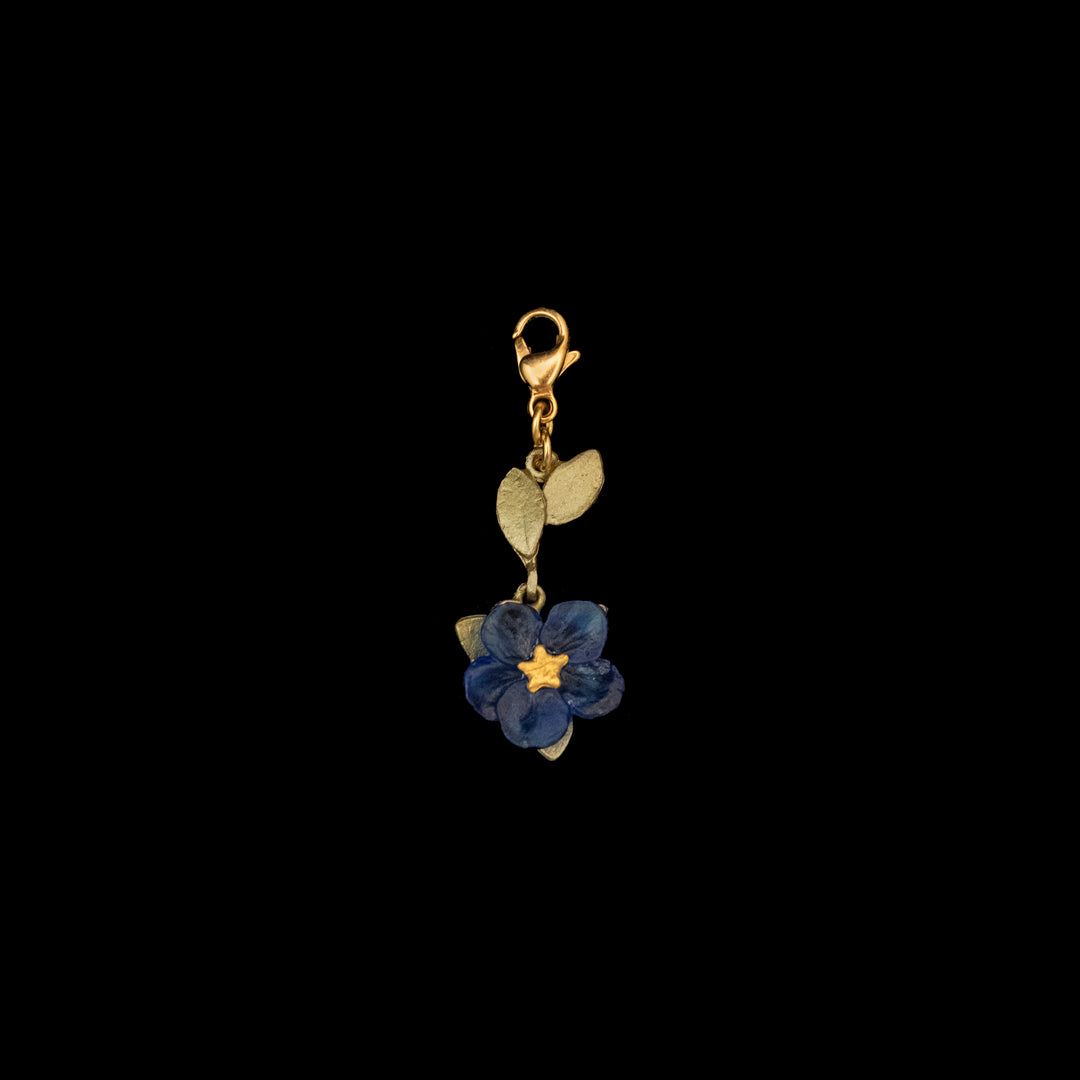 Image of the Michael Michaud Blue Violet Charm on a black background