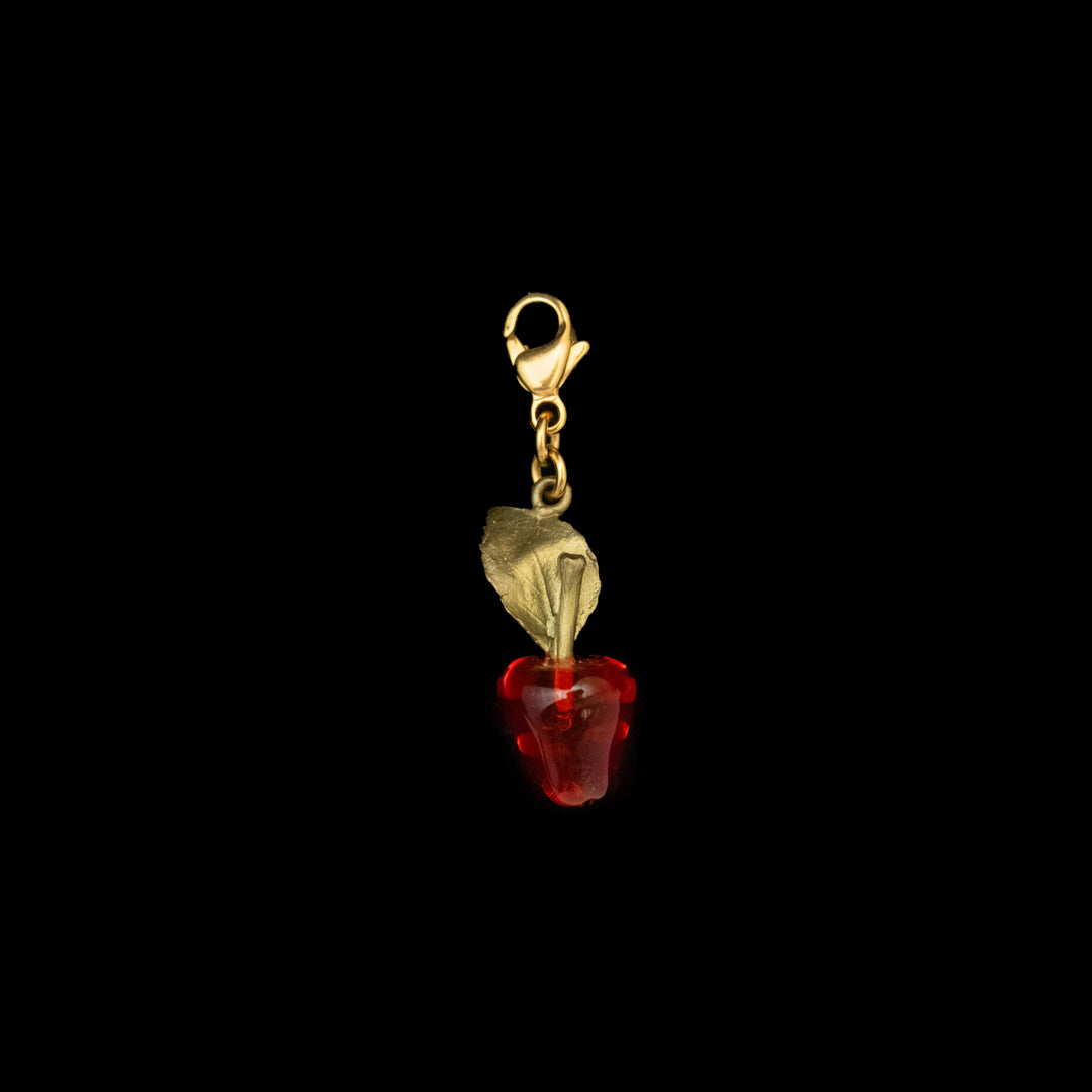 Image of the Michael Michaud Delicious Apple Charm on a black background