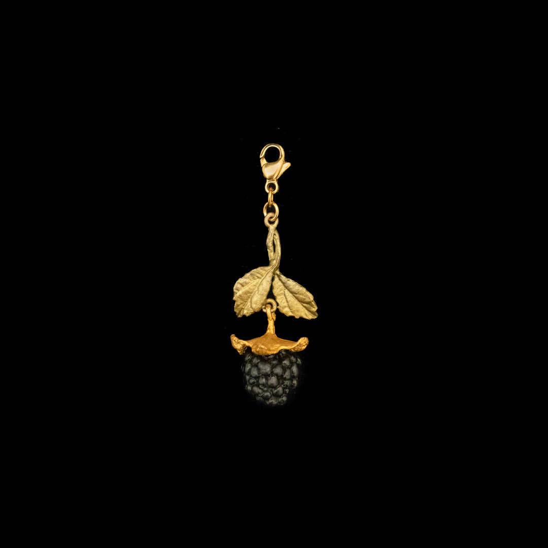 Image of the Michael Michaud Blackberry Charm on a black background