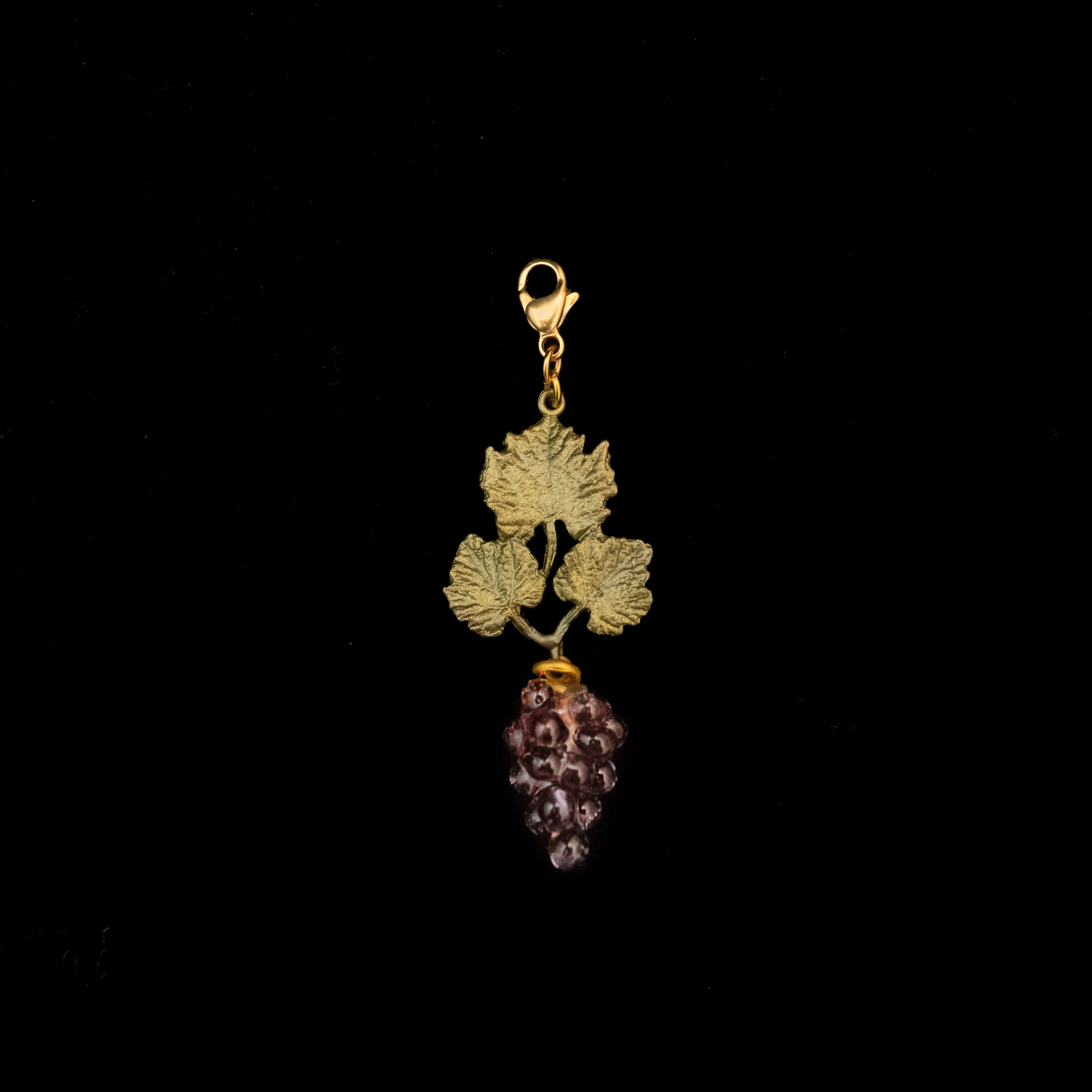 Image of the Michael Michaud Wild Grape Vine Charm on a black background