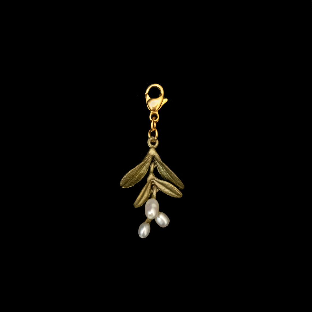 Garden Vine Charm with a gold clasp, green leaves in hand-patinated bronze, and three white freshwater pearls, photographed against a solid black background.