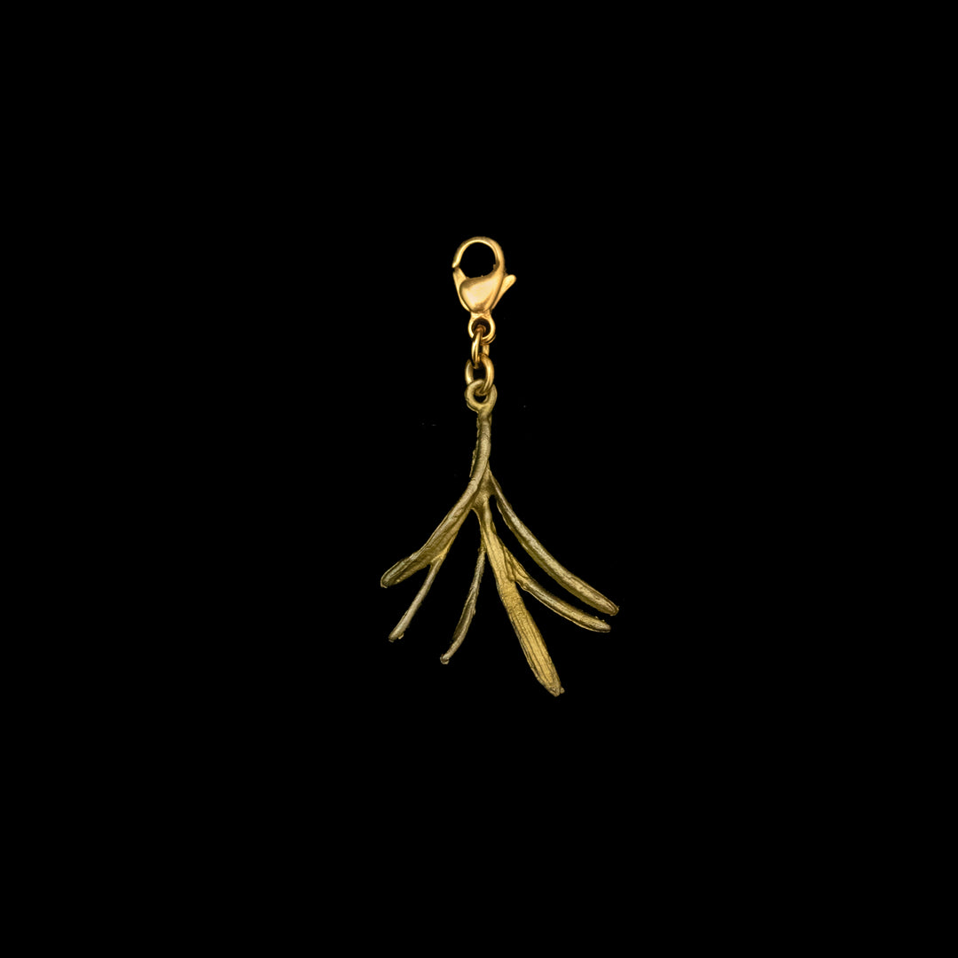 A bronze charm in the shape of a sprig of rosemary with a green patina finish.