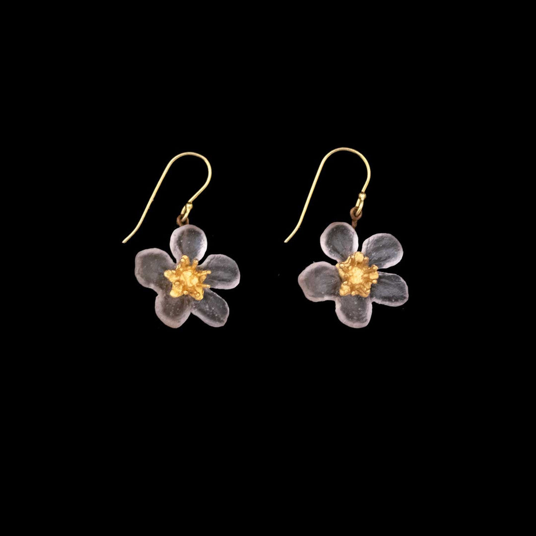 A pair of earrings featuring handcrafted glass flower pendants with translucent petals and yellow centers, attached to gold hooks, displayed on a black background—a delicate touch of floral-inspired jewelry.