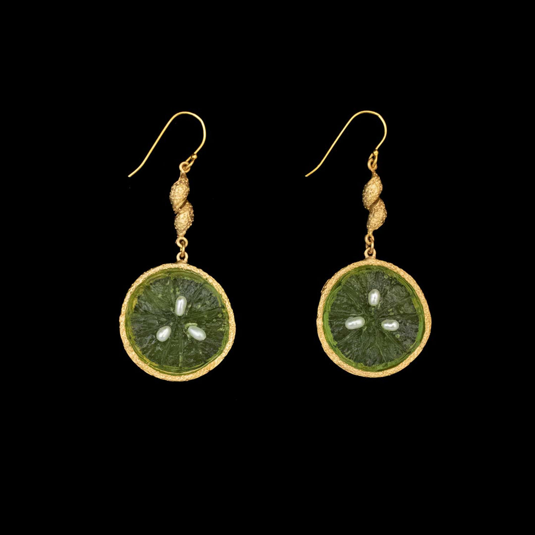 A pair of gold plated Lime Earrings featuring green circular glass pendants resembling citrus fruit slices, displayed on a black background. Part of the Michael Michaud Jewelry Collection, these are stunning examples of handcrafted jewelry.