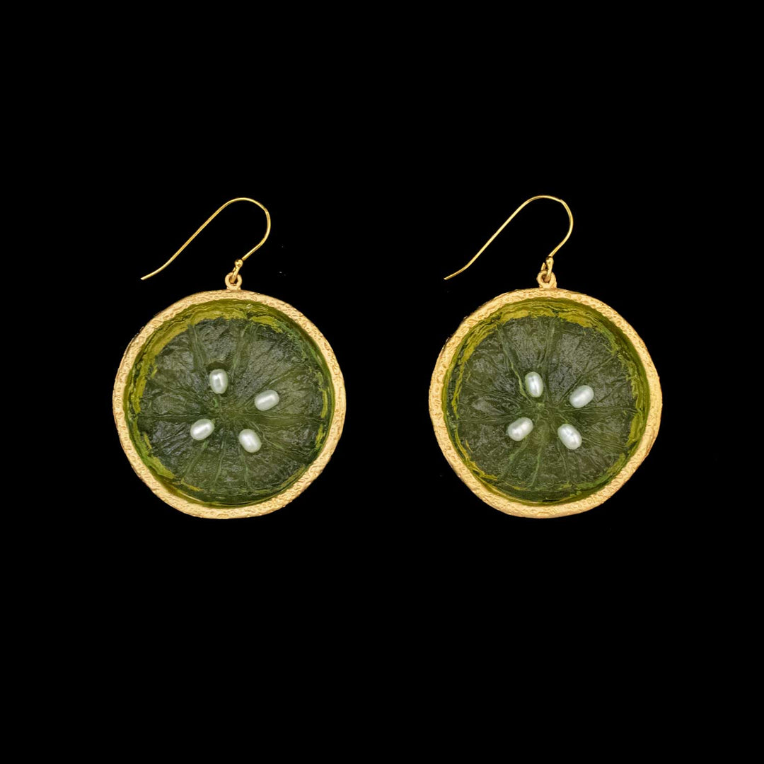 A pair of round, green Lime Earrings with gold plated edges and hooks, displayed on a black background—perfect for lovers of botanical jewelry.