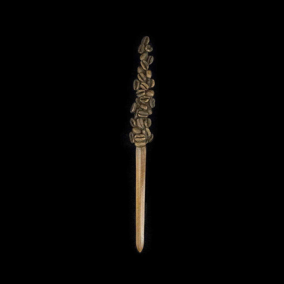 Image of the Michael Michaud Coffee Bean Letter Opener on a black background