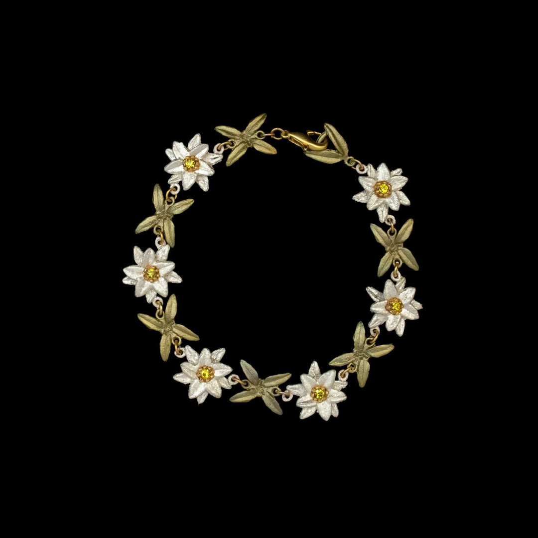 A gold Edelweiss bracelet featuring alternating white and yellow flower-shaped links, connected by small gold rings and inspired by The Sound of Music jewelry, displayed on a black background.