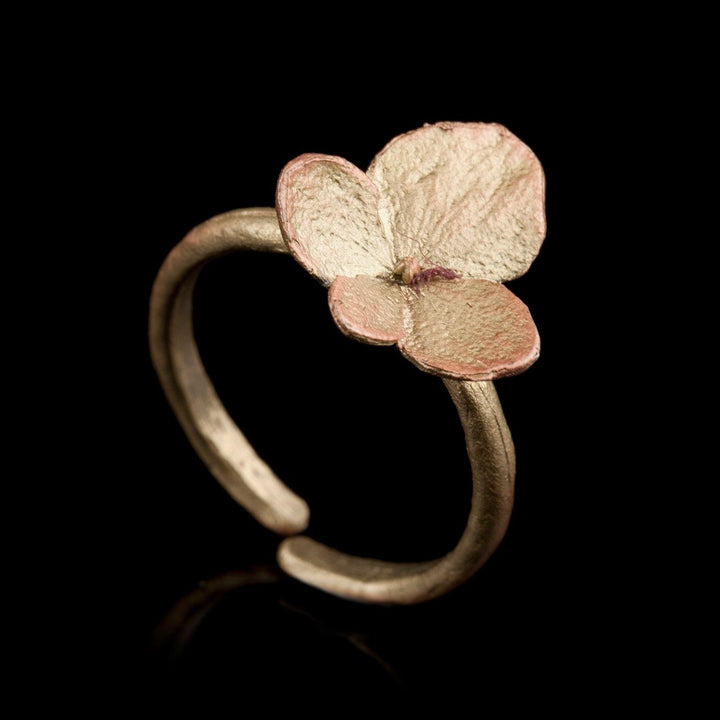 Image of the Michael Michaud Hydrangea Ring on a black background