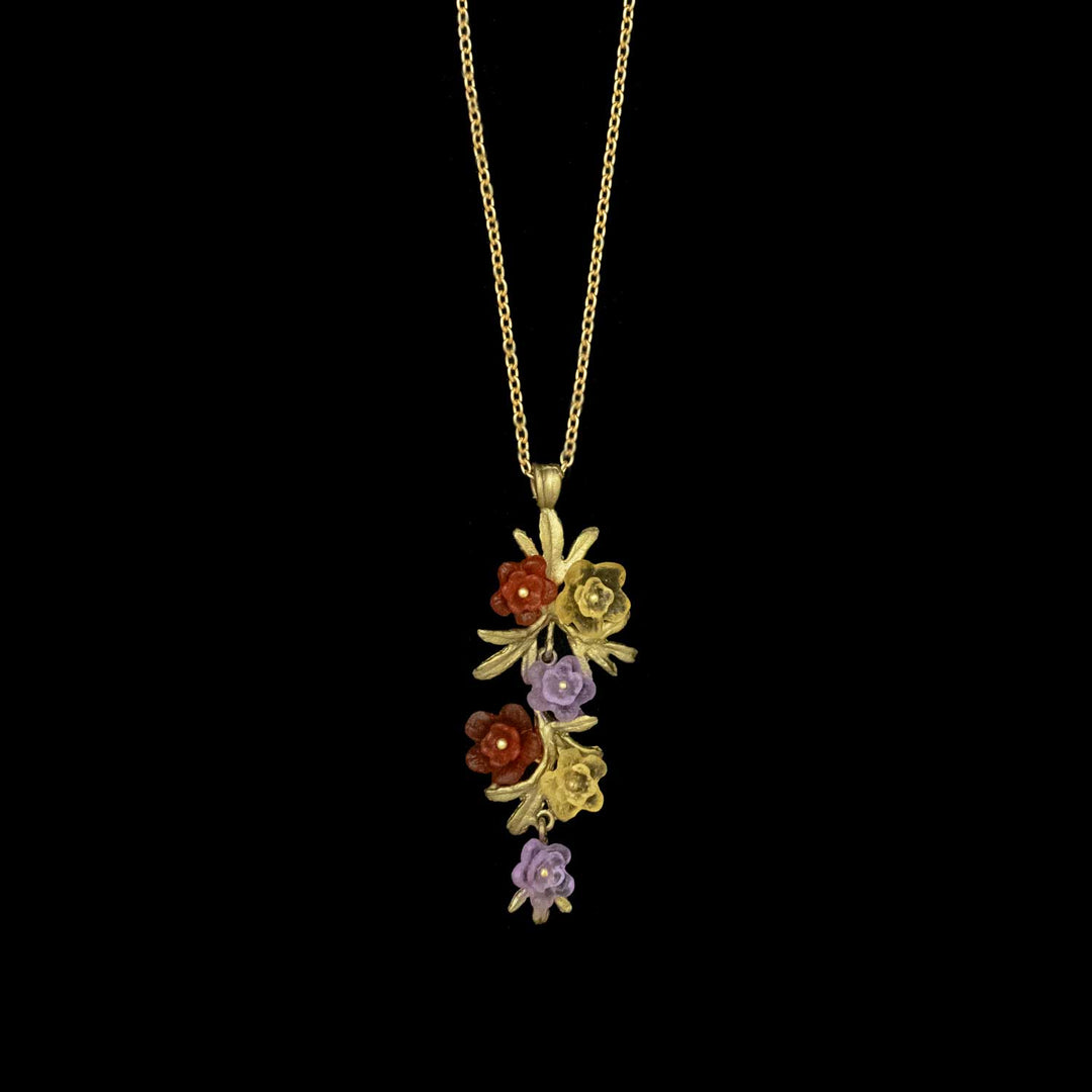 Image of the Michael Michaud Mums Pendant - Long on a black background