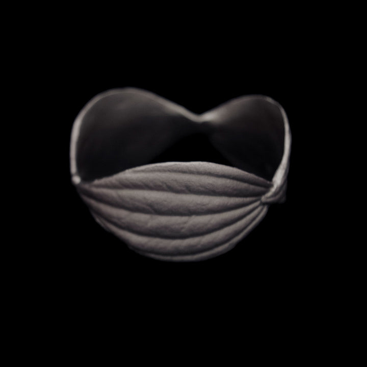 Image of the Michael Michaud Piper Napkin Rings on a black background