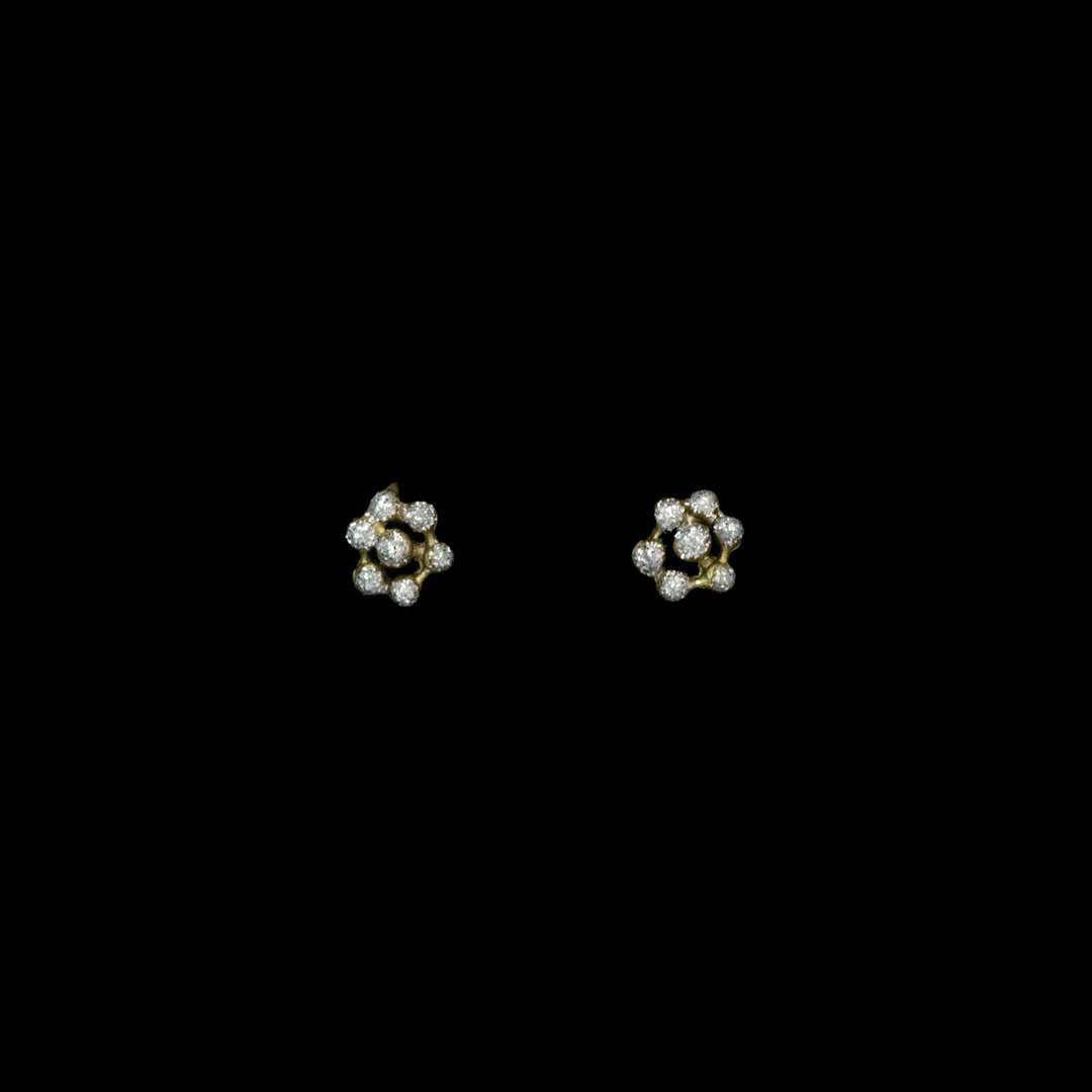 Pair of floral earrings with crystal dust dots on a black background