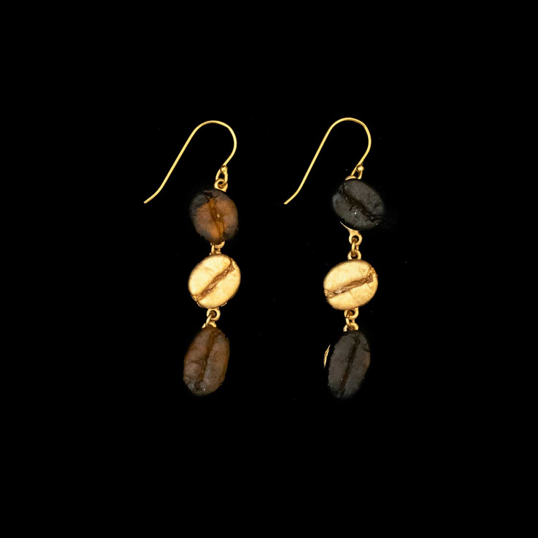 Roasted Coffee Bean Earrings - Long Wire: Dangling earrings with gold hooks, each featuring three vertically stacked coffee bean-shaped beads in brown and gold, displayed against a black background.