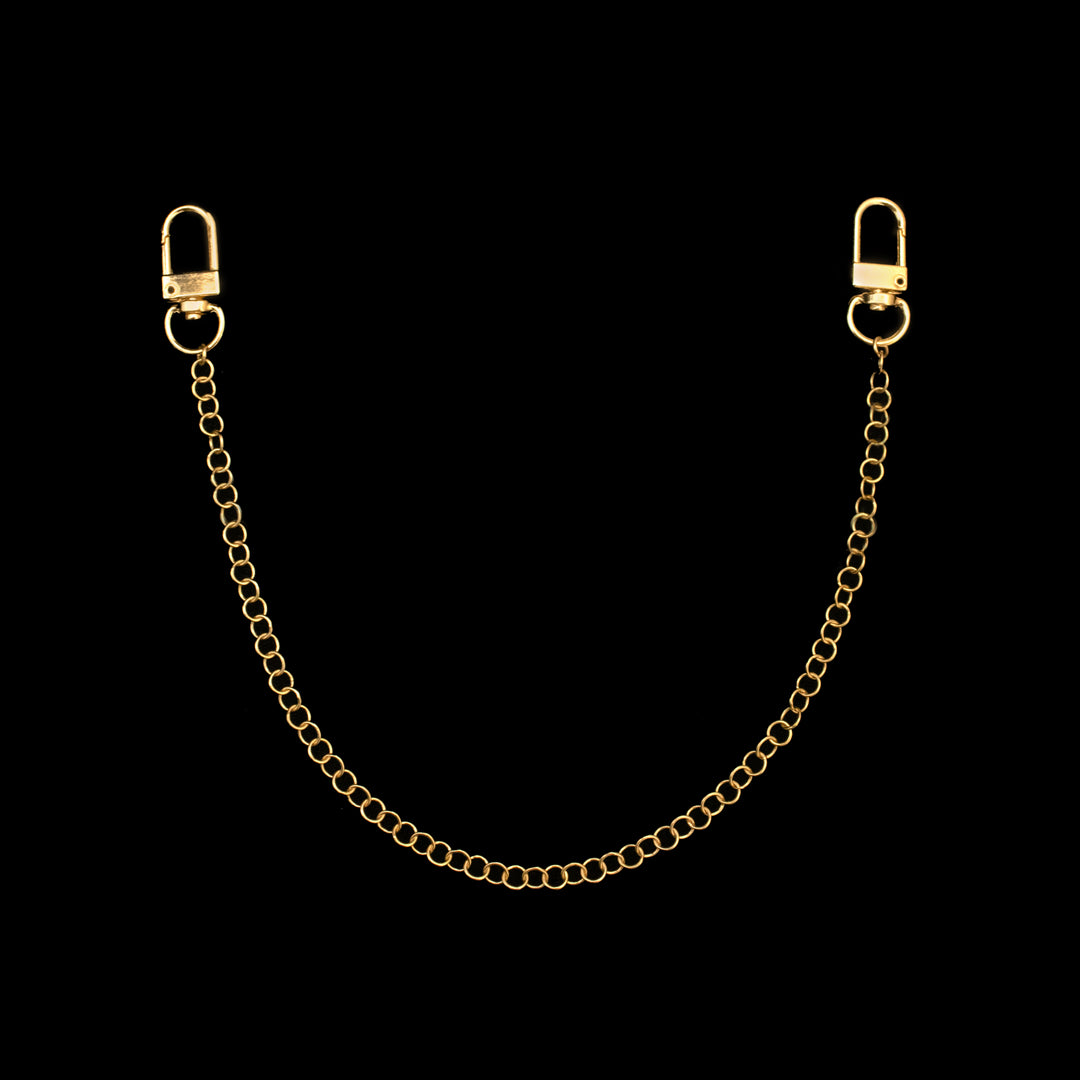 A gold chain with clasps at both ends is displayed against a black background.
