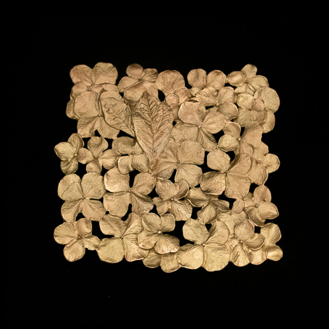 Image of the Michael Michaud Hydrangea Trivet on a black background