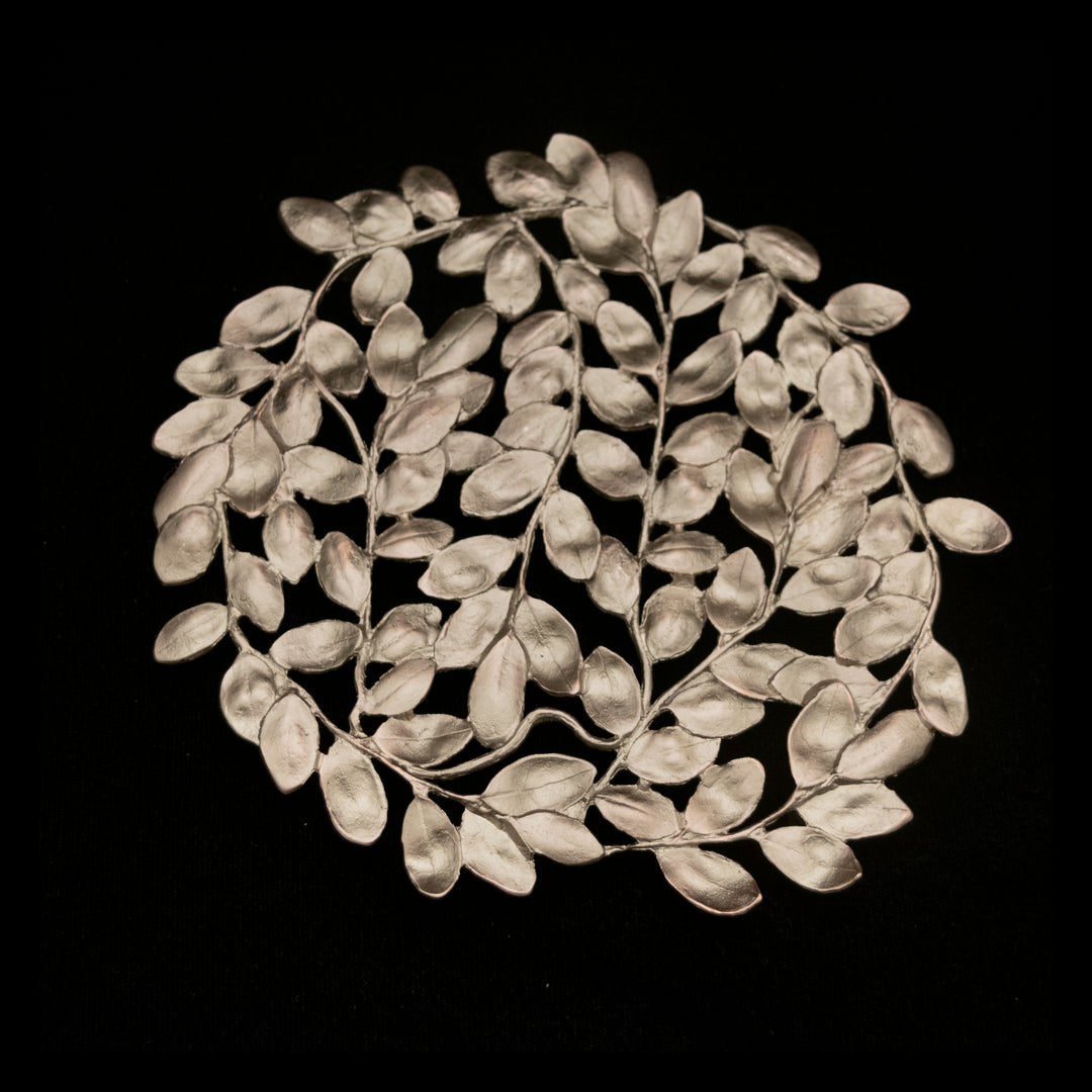 Image of the Michael Michaud Boxwood Trivet on a black background