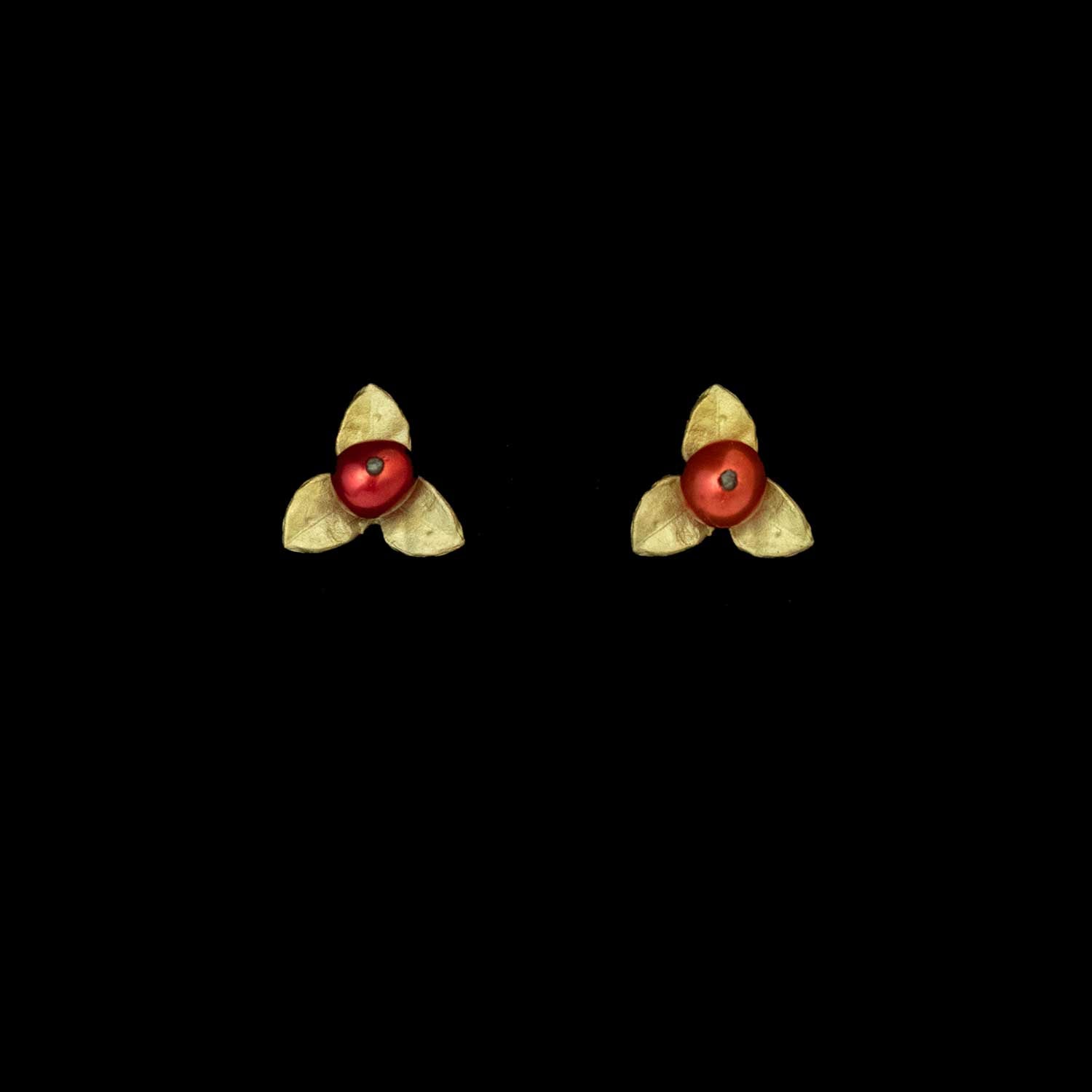 A pair of Unroasted Coffee Bean Earrings - Post, featuring small red freshwater pearls with three green-colored triangular petals, displayed against a plain black background.
