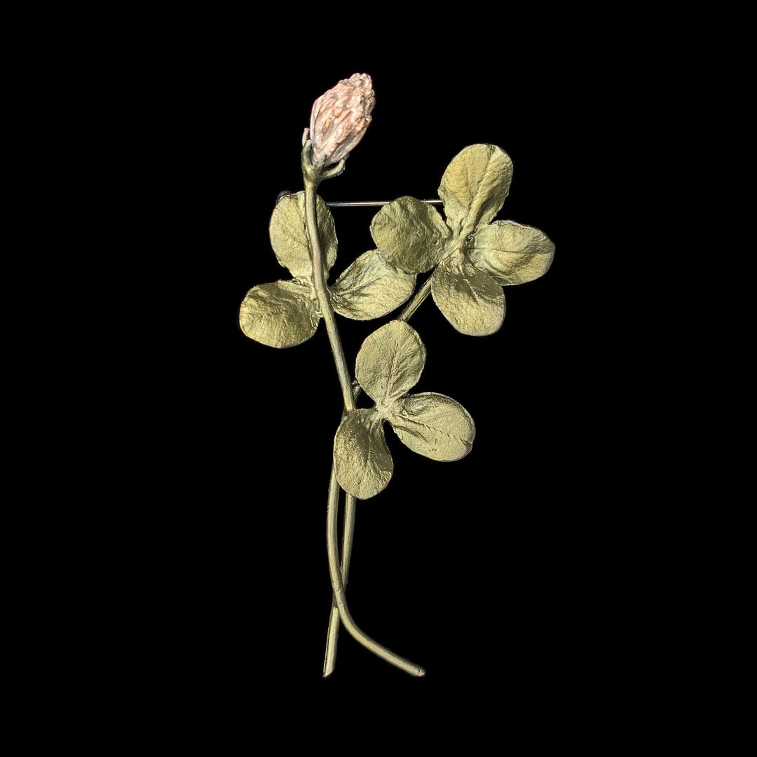 Image of the Michael Michaud Clover Brooch on a black background