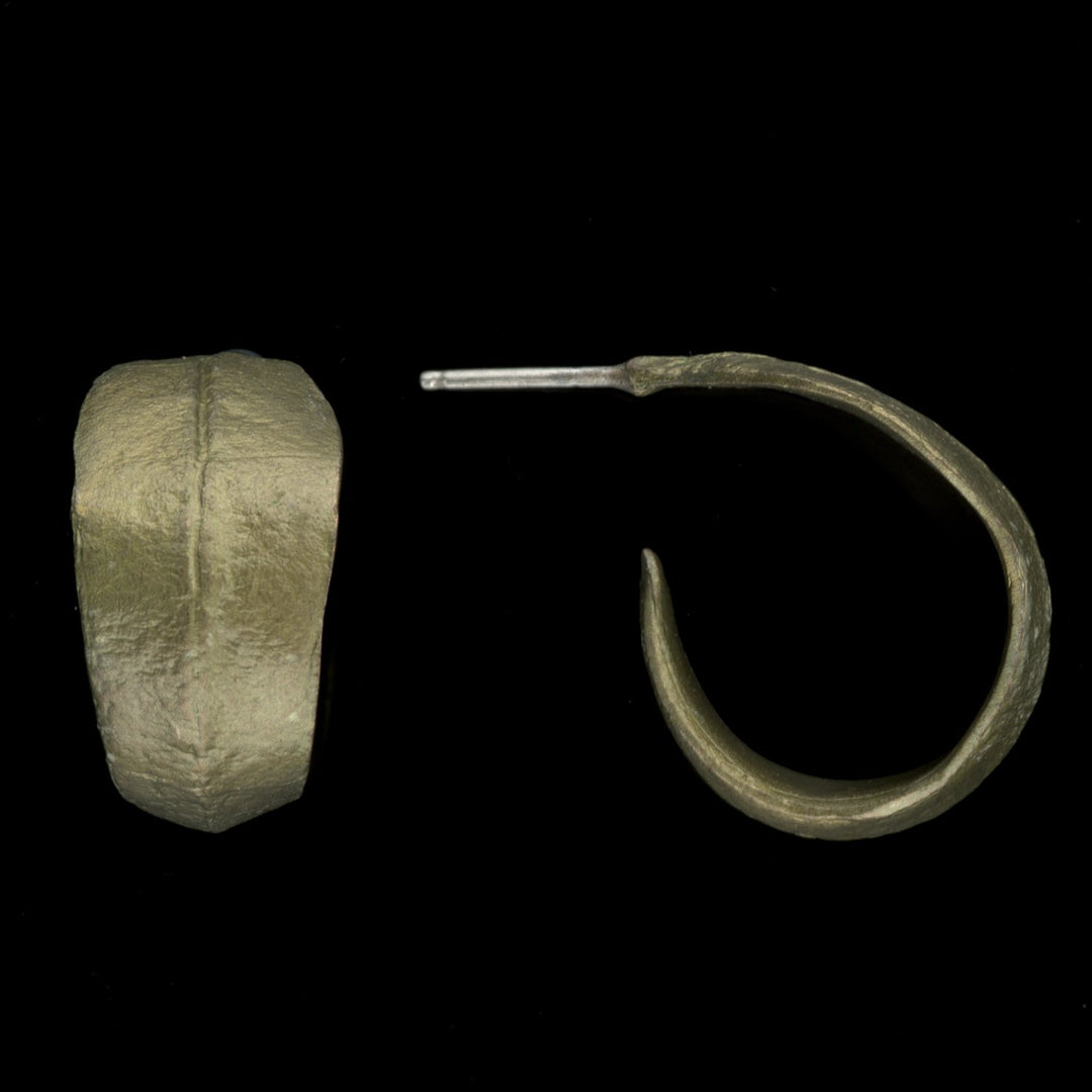 A pair of green-colored hoop earrings with a textured design, displayed against a black background.