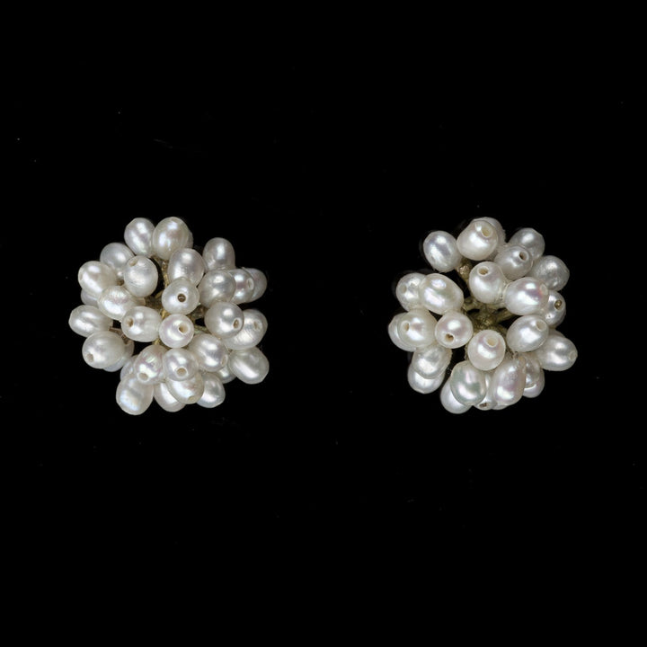 Image of the Michael Michaud Dandelion Earrings on a black background