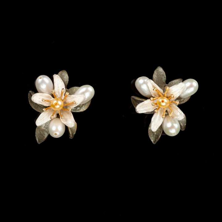 Image of the Michael Michaud Orange Blossom Earrings - Flower Button on a black background