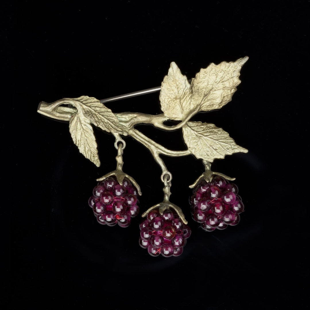 Image of the Michael Michaud Raspberry Brooch on a black background