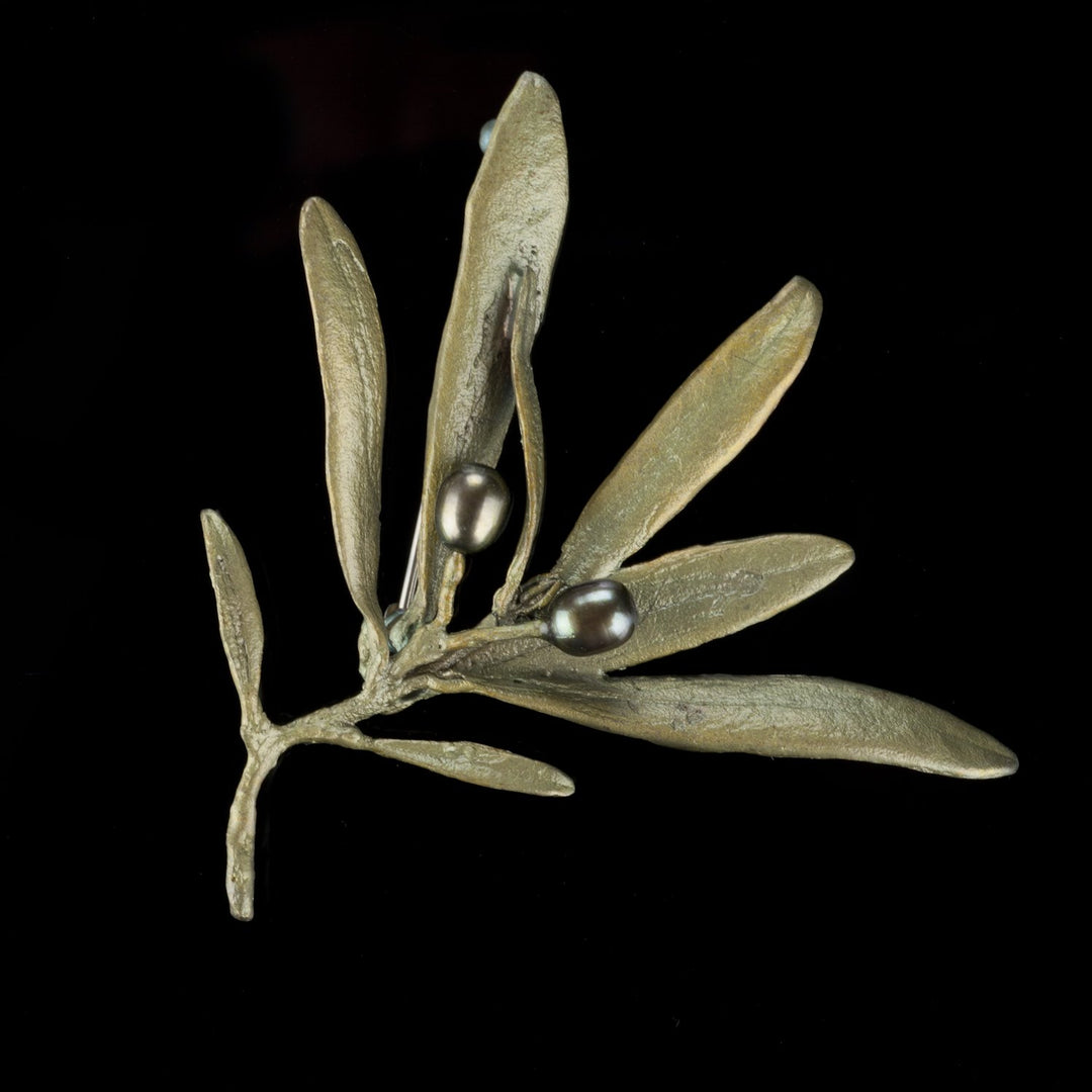 Image of the Michael Michaud Olive Brooch on a black background