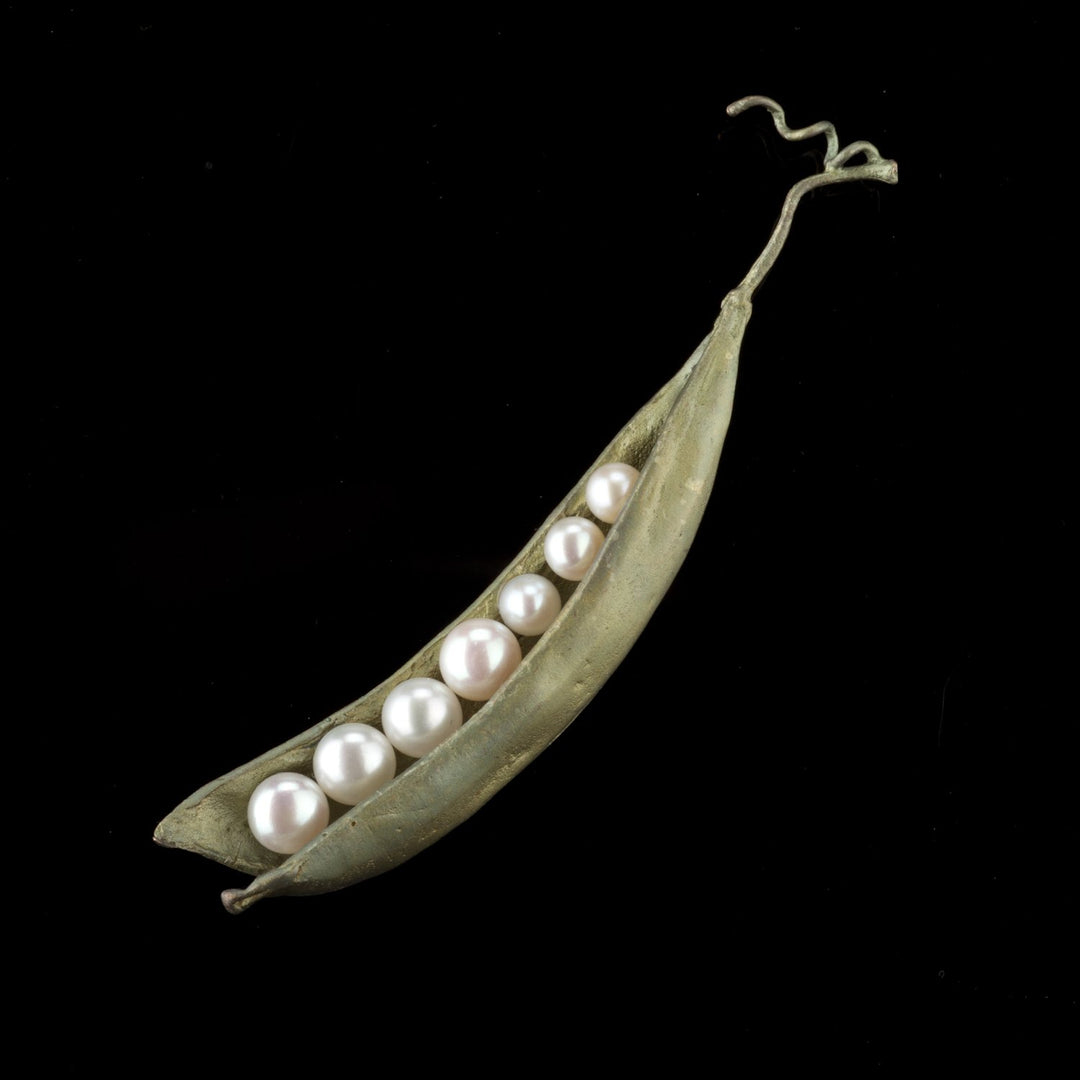 Image of the Michael Michaud Pea Pod Brooch - 7 Pearls on a black background