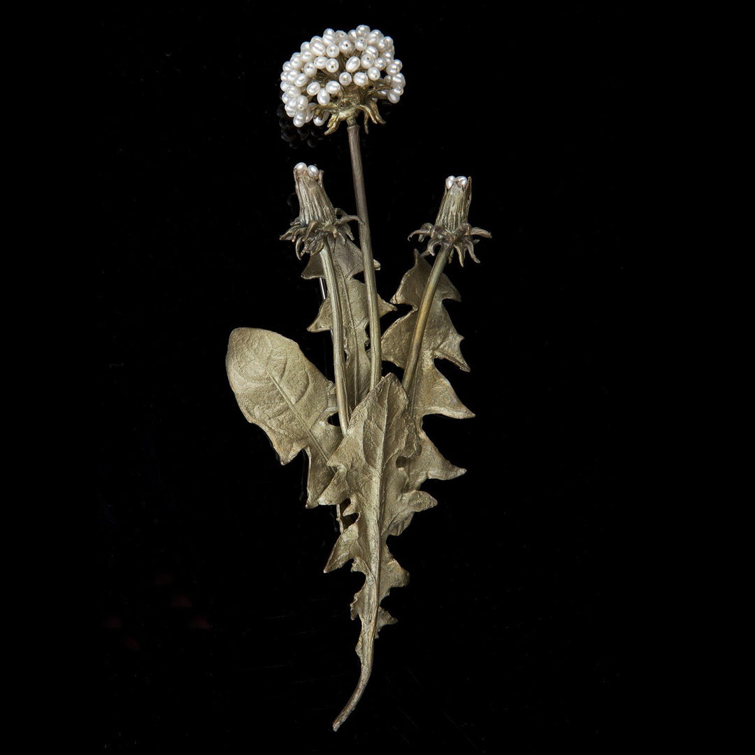 Image of the Michael Michaud Dandelion Brooch on a black background