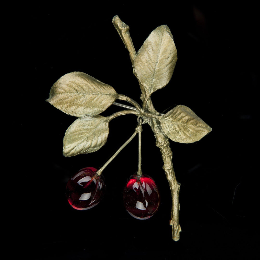 Image of the Michael Michaud Morello Cherry Brooch on a black background