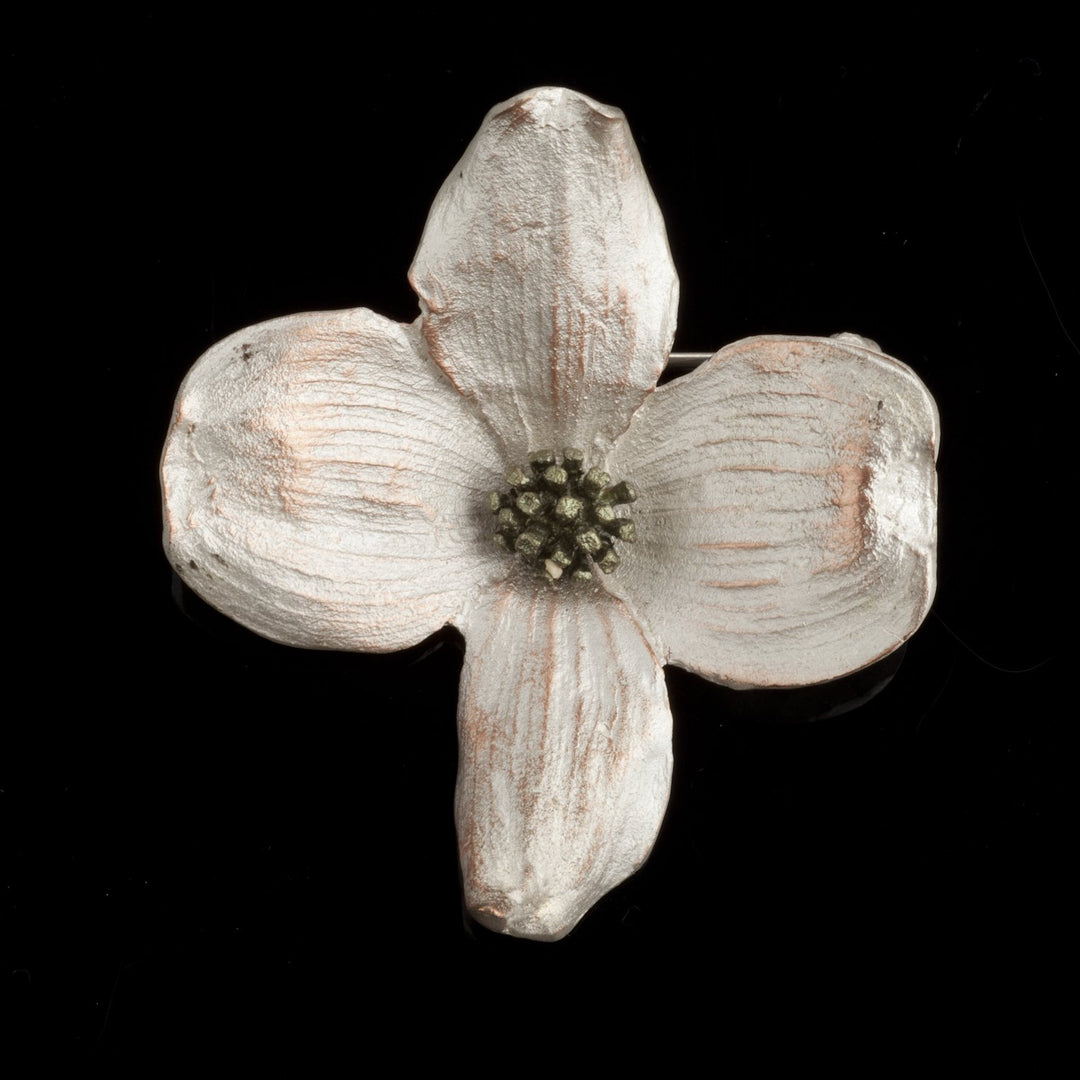 Image of the Michael Michaud Dogwood Brooch on a black background