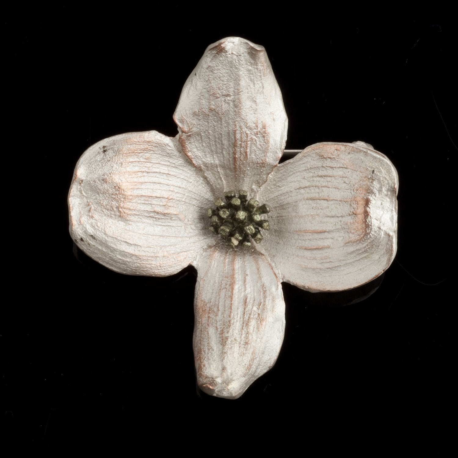 Image of the Michael Michaud Dogwood Brooch on a black background
