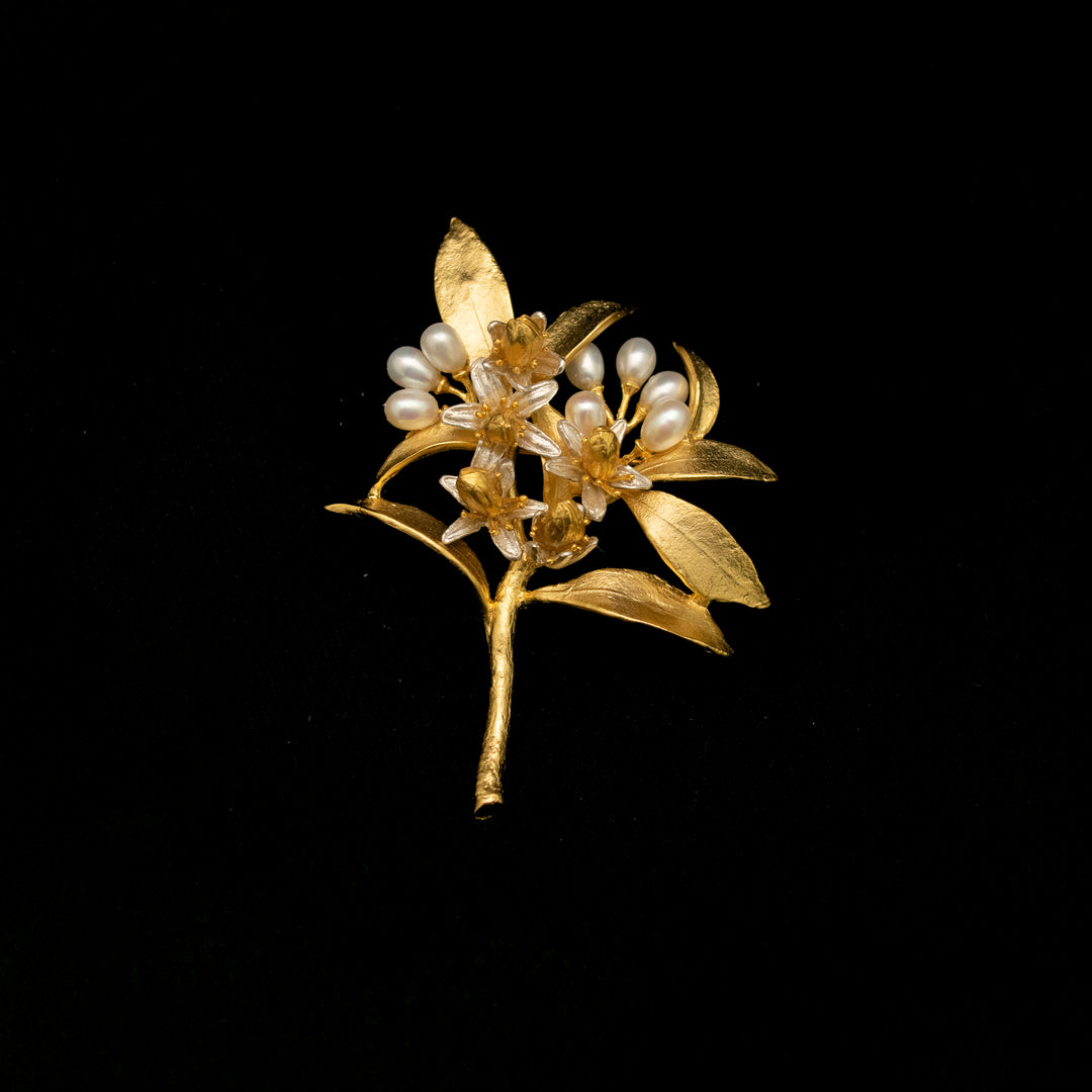 Image of the Michael Michaud Fine Orange Blossom Statement Brooch on a black background