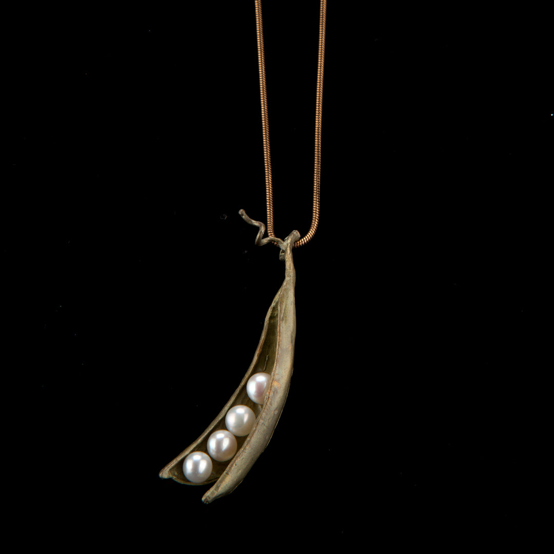 Image of the Michael Michaud Pea Pod Pendant - 4 Pearls on a black background