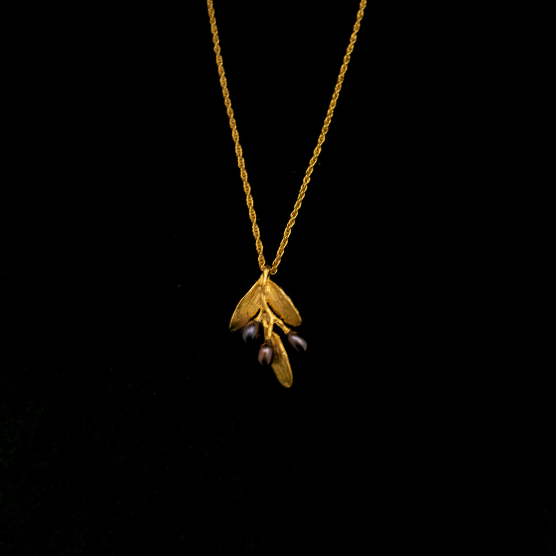 Image of the Michael Michaud Fine Olive Gold Pendant on a black background