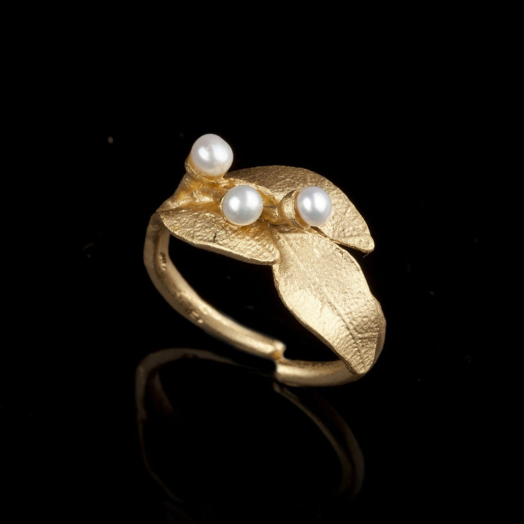 An adjustable bronze ring with 24kt gold plate and white freshwater pearls, designed to resemble laurel leaves.