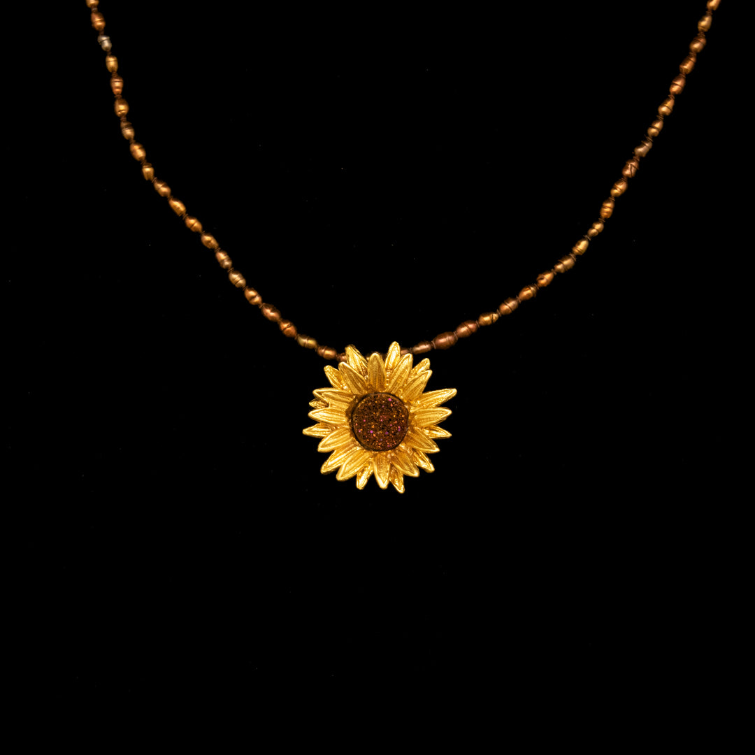 Image of the Michael Michaud Fine Sunflower Pendant Brown Pearls on a black background