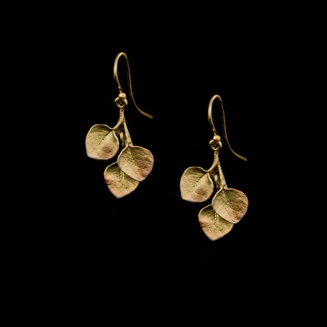 Image of the Michael Michaud Fine Survivor Tree Leaf Earrings on a black background