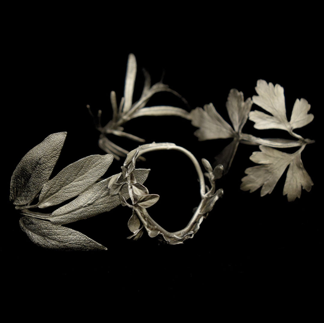 Image of the Michael Michaud Herb Assortment for Four Napkin Rings - Pewter on a black background