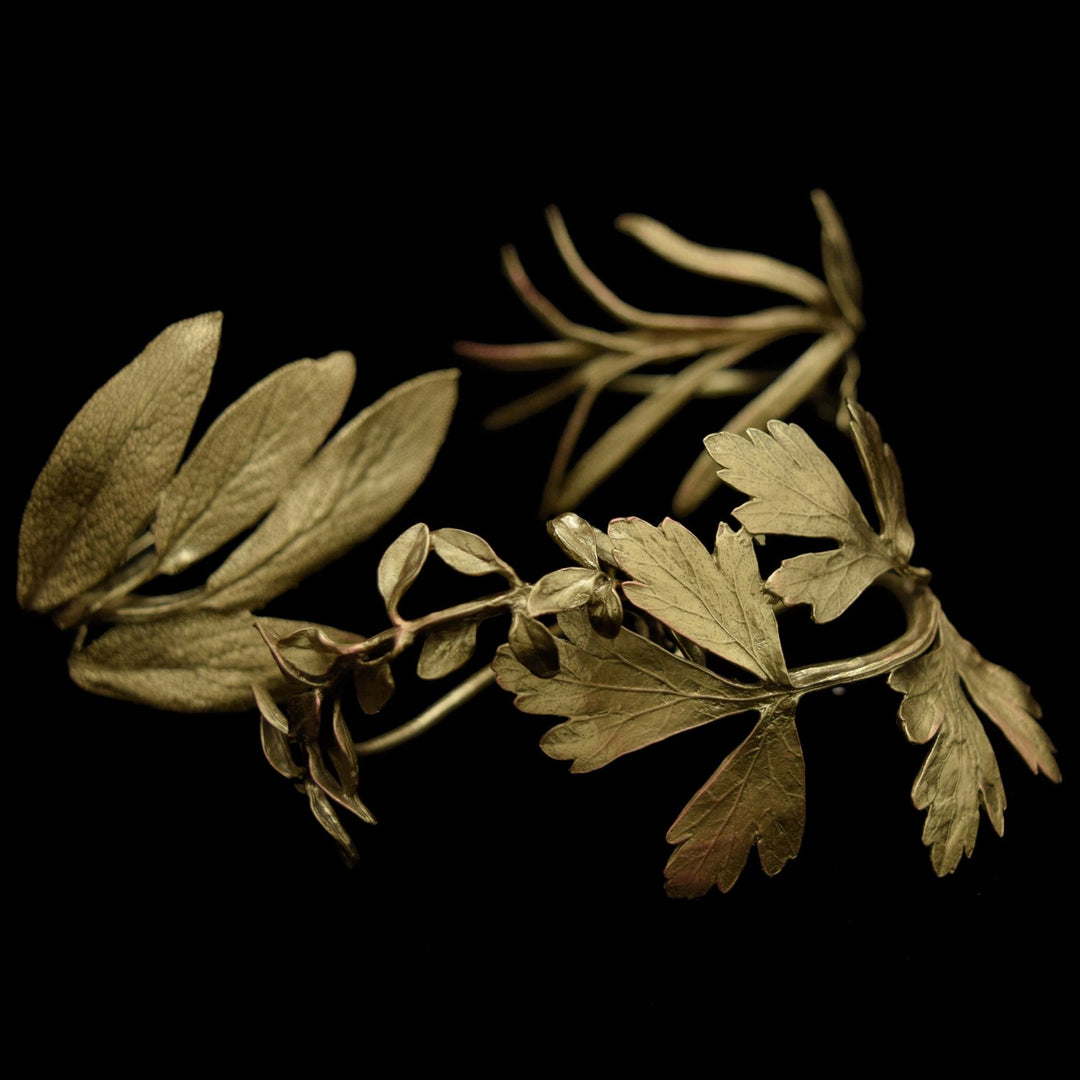 Image of the Michael Michaud Herb Assortment for Four Napkin Rings - Bronze on a black background