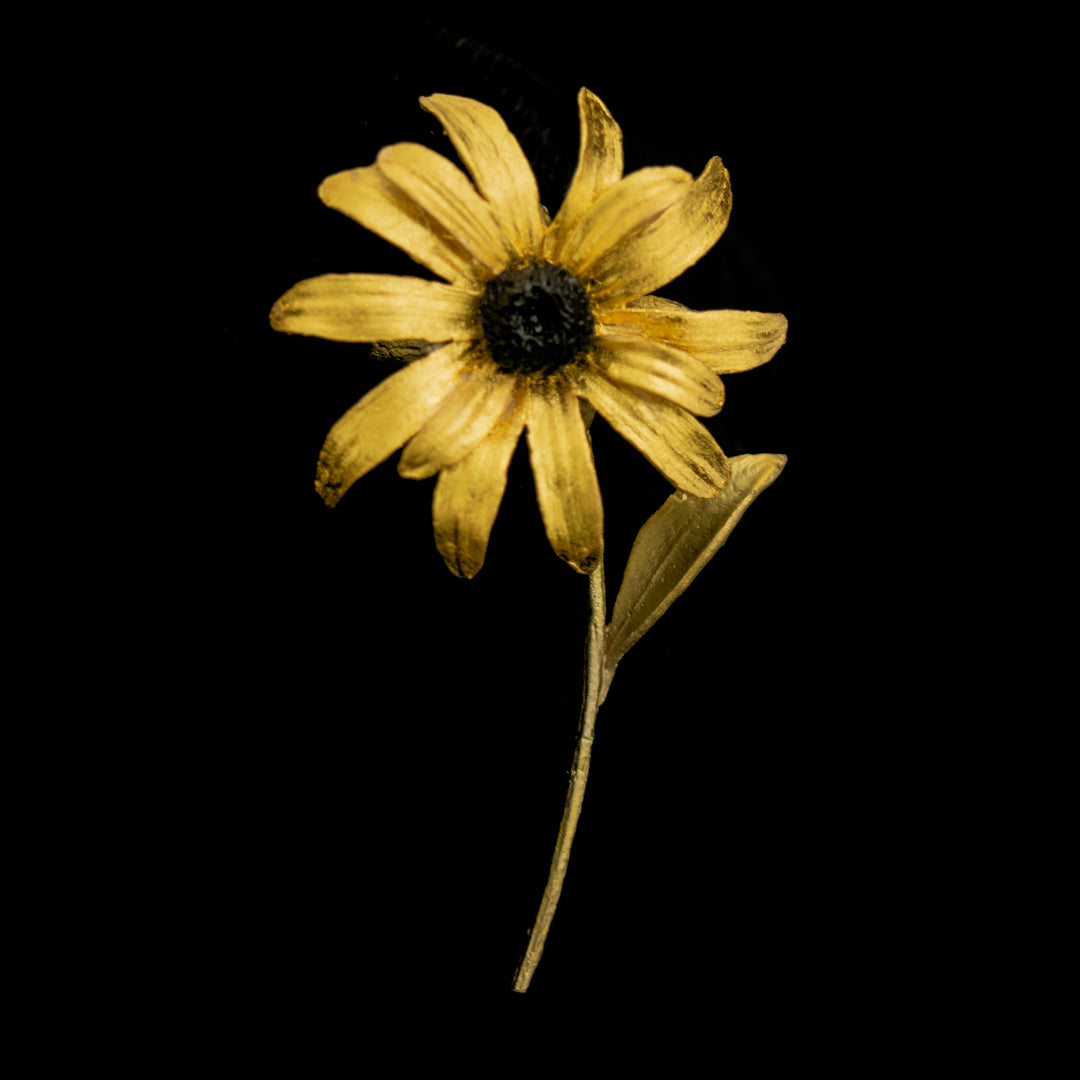 Image of the Michael Michaud Black-Eyed Susan Brooch on a black background