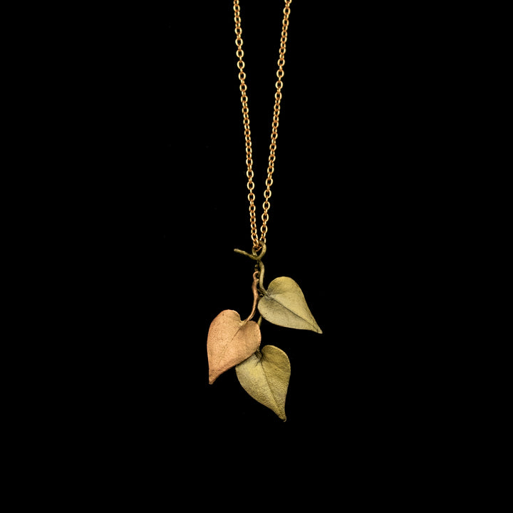 Image of the Michael Michaud Sweet Potato Vine Pendant on a black background