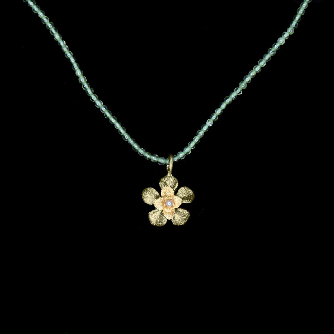 Image of the Michael Michaud Desert Flower Pendant - Peridot on a black background